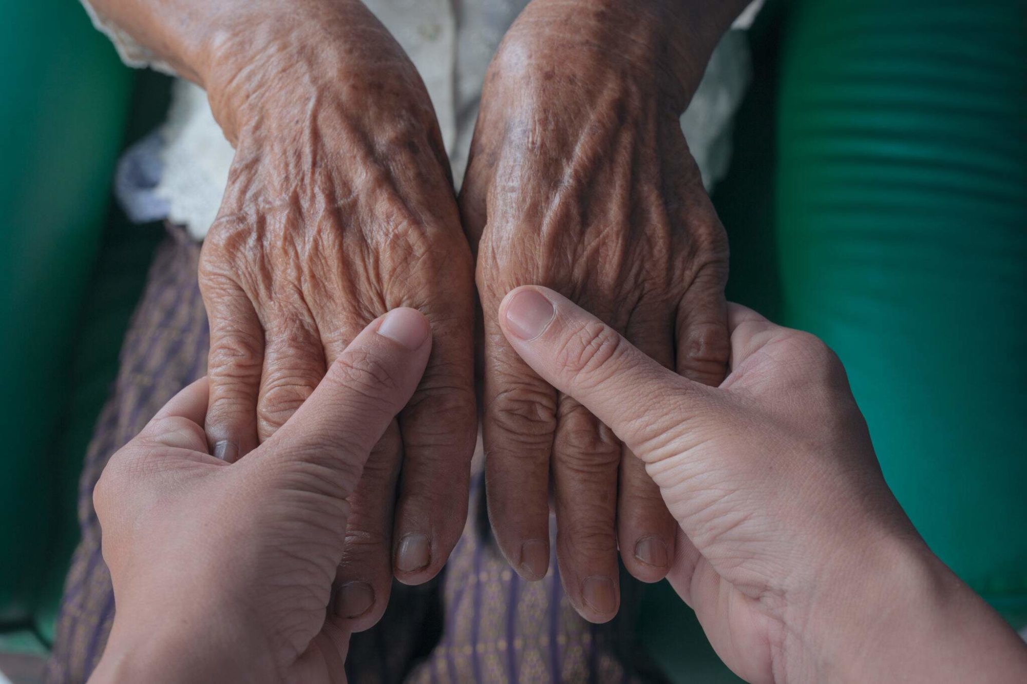 Mains d'un senior dans les mains d'un homme